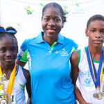 Sagicor Rep Sandwiched by the Champion Girl and Boy at the championships.
