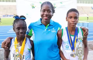 Sagicor Rep Sandwiched by the Champion Girl and Boy at the championships.